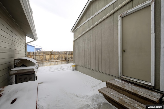 snow covered patio with fence