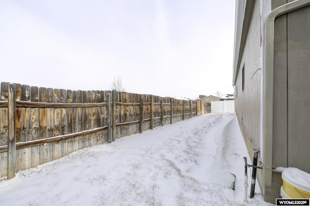 yard covered in snow with fence