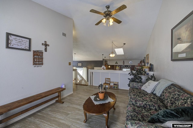 living area featuring visible vents and ceiling fan