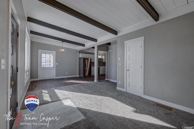 living room with a chandelier and beamed ceiling