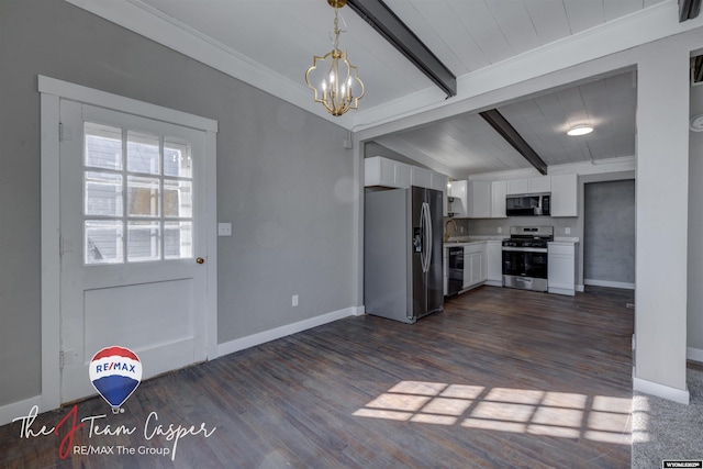 kitchen with pendant lighting, sink, white cabinetry, stainless steel appliances, and lofted ceiling with beams