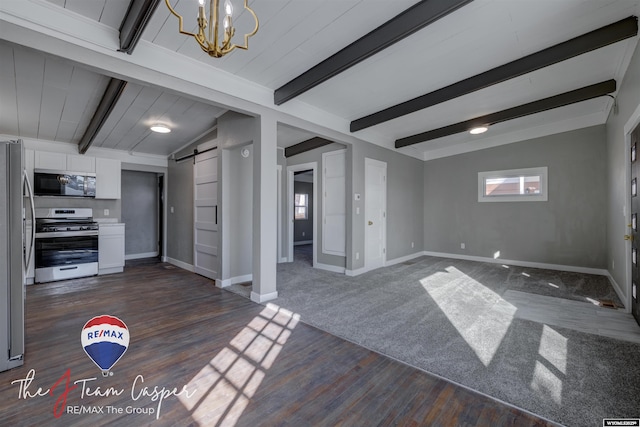 unfurnished living room featuring a barn door, dark wood-type flooring, vaulted ceiling with beams, and a chandelier