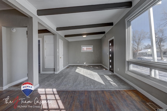 unfurnished room with dark wood-type flooring and beamed ceiling