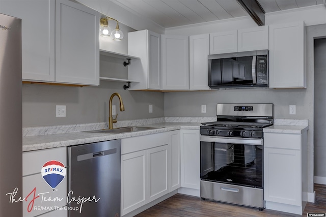 kitchen featuring pendant lighting, sink, white cabinets, and appliances with stainless steel finishes