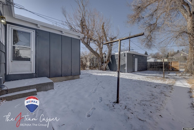 snowy yard with a storage unit