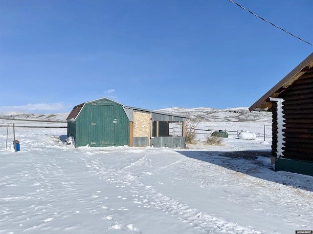 snow covered structure featuring a mountain view