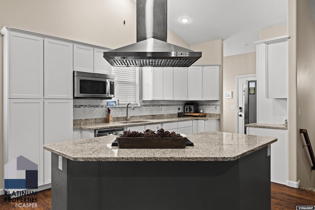 kitchen with a kitchen island, island range hood, sink, stainless steel appliances, and light stone countertops