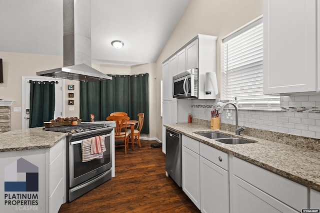 kitchen with sink, white cabinetry, appliances with stainless steel finishes, island exhaust hood, and light stone countertops