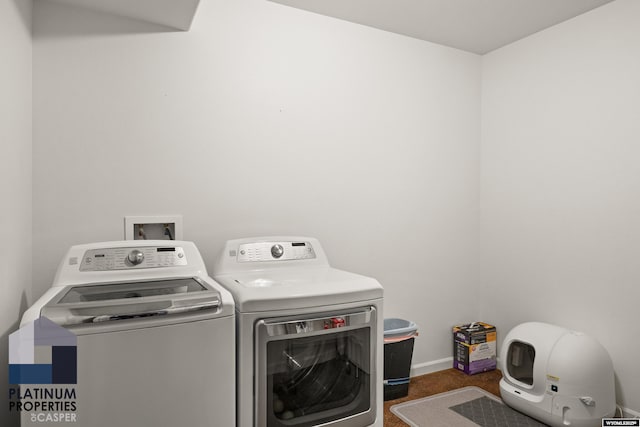 laundry area with dark carpet and washer and clothes dryer