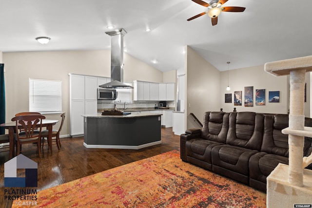 living room featuring high vaulted ceiling, dark hardwood / wood-style floors, sink, and ceiling fan