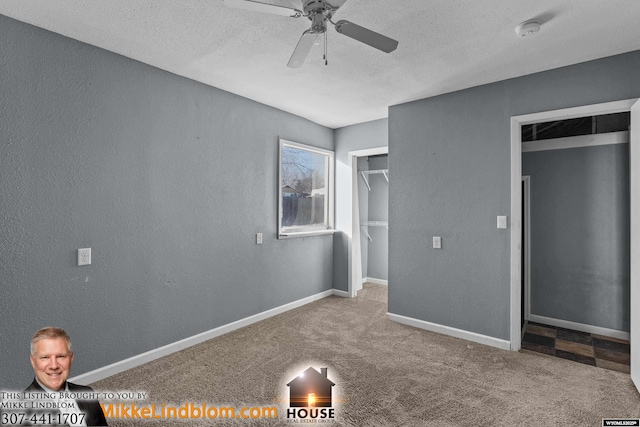 unfurnished bedroom featuring ceiling fan, light colored carpet, and a textured ceiling