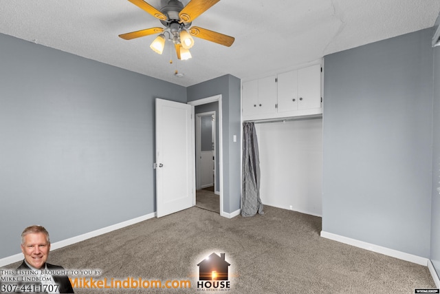 unfurnished bedroom featuring ceiling fan, a closet, a textured ceiling, and carpet flooring