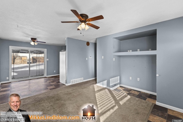 unfurnished living room featuring ceiling fan, a textured ceiling, and dark colored carpet