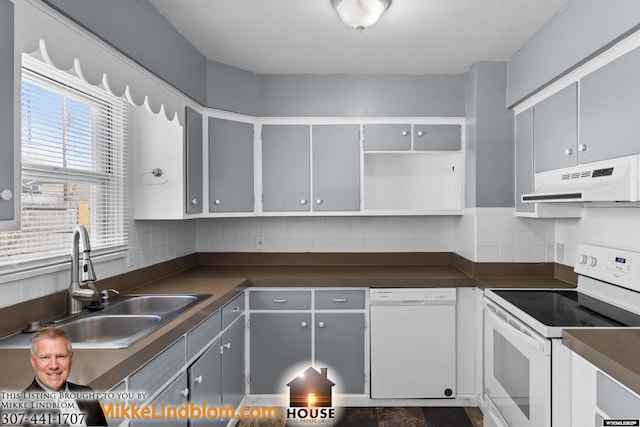 kitchen with white appliances, gray cabinets, sink, and decorative backsplash