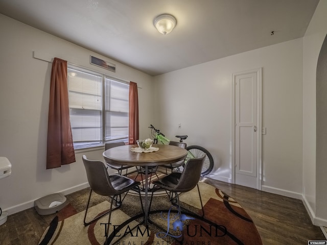 dining area featuring dark hardwood / wood-style floors