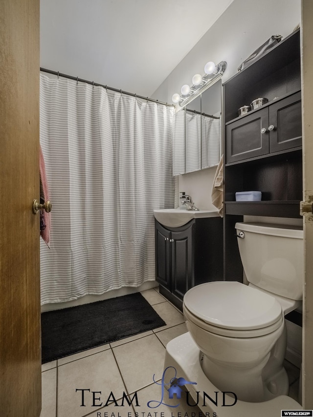 bathroom featuring tile patterned flooring, sink, and toilet