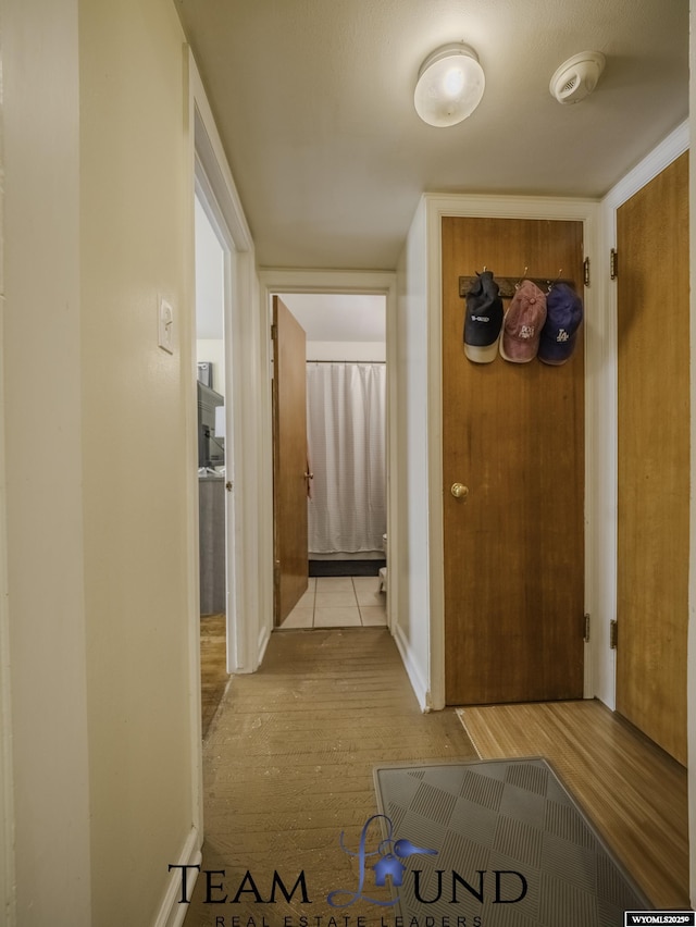 corridor with light hardwood / wood-style flooring