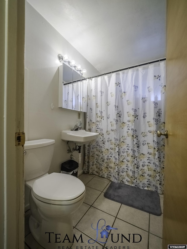 bathroom with tile patterned flooring and toilet