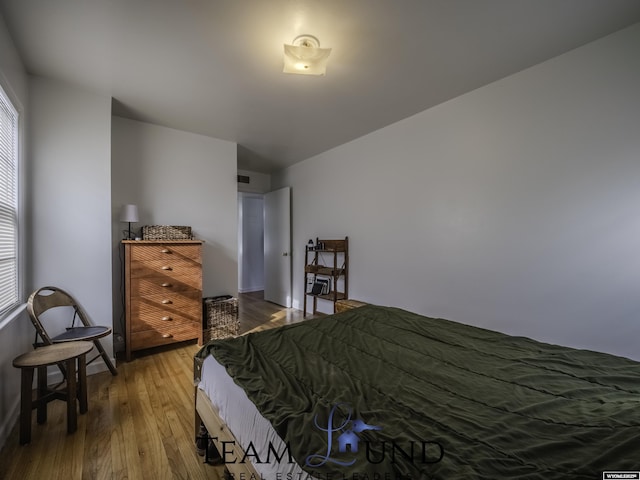 bedroom with hardwood / wood-style flooring