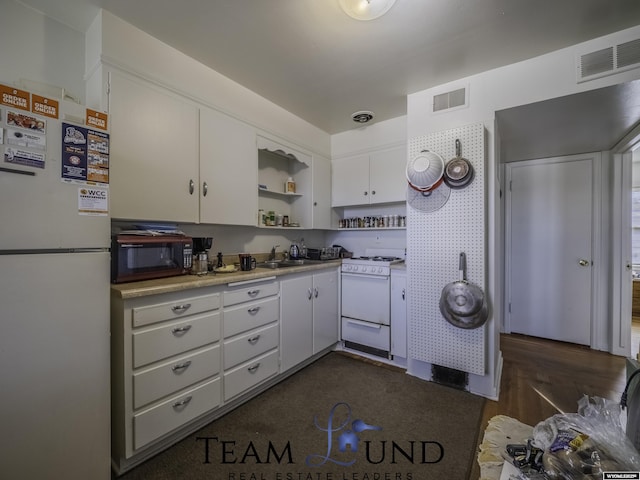 kitchen featuring white cabinetry, white appliances, and sink