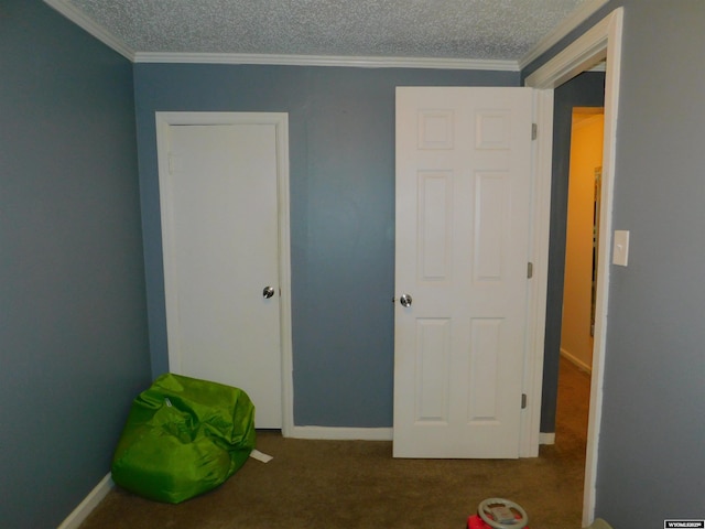 unfurnished bedroom with ornamental molding, carpet flooring, and a textured ceiling