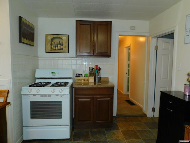 kitchen featuring dark brown cabinets and white range with gas stovetop