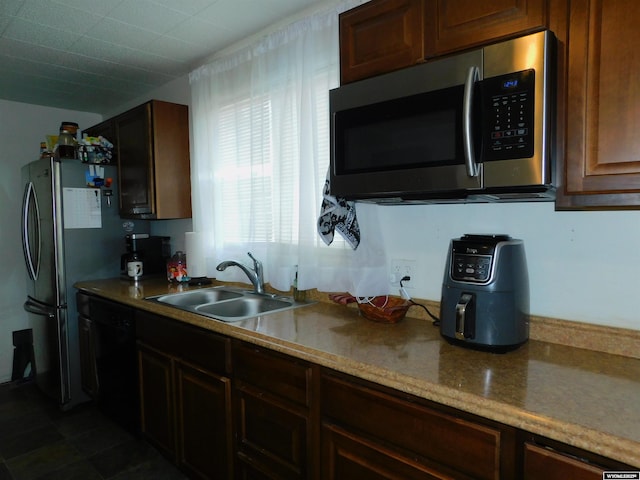 kitchen featuring sink and black dishwasher