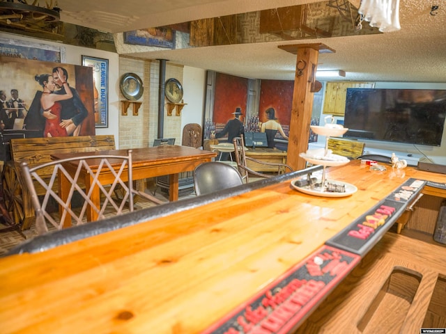 interior space featuring a textured ceiling and a wood stove