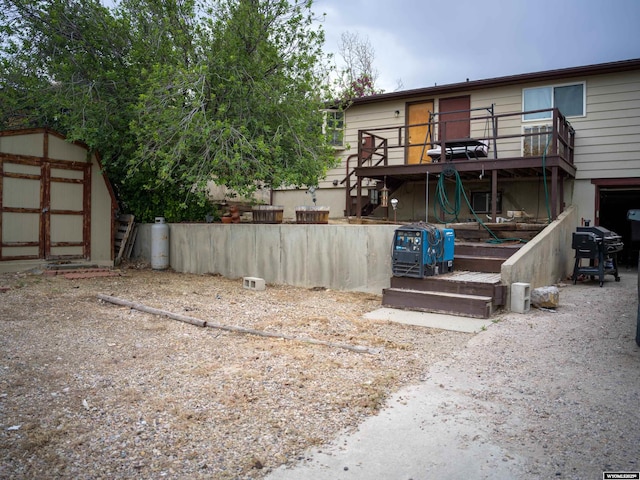 rear view of property featuring a storage shed