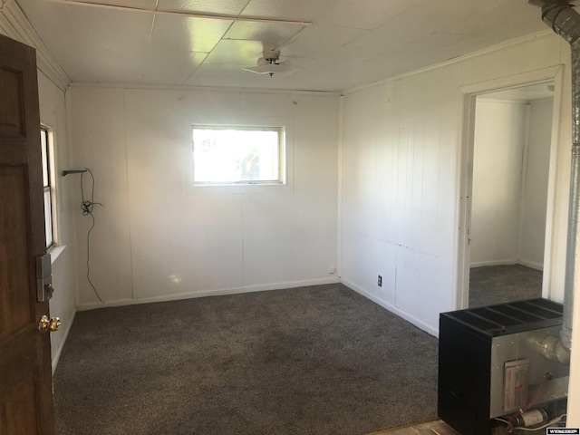 spare room with dark colored carpet