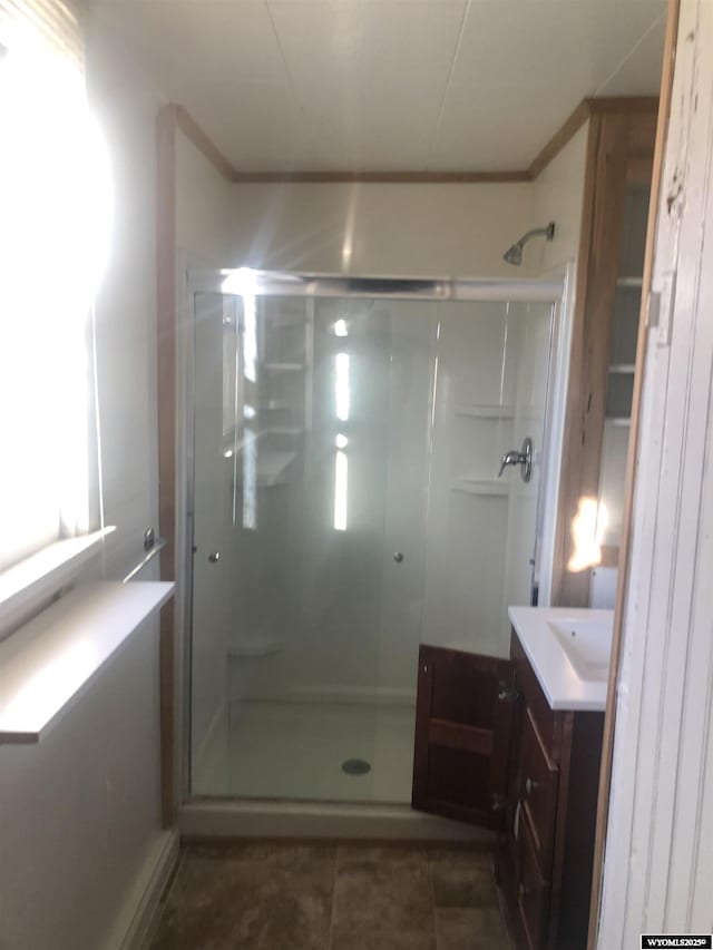 bathroom with a stall shower, vanity, and tile patterned floors