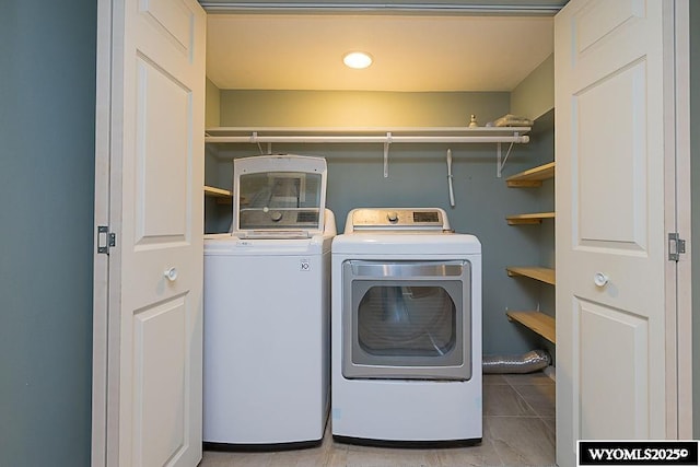 washroom featuring separate washer and dryer and light tile patterned floors