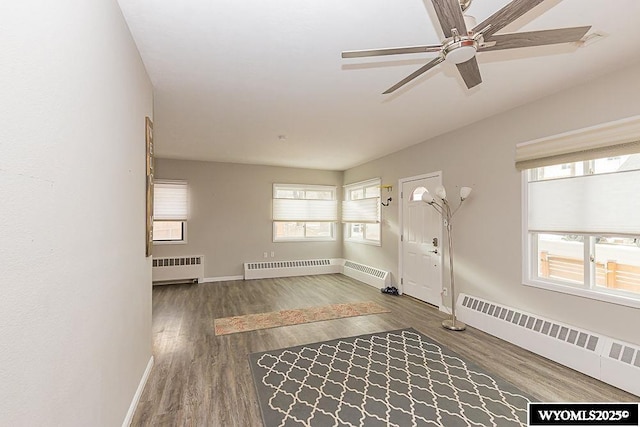 foyer with radiator, a healthy amount of sunlight, and a baseboard heating unit