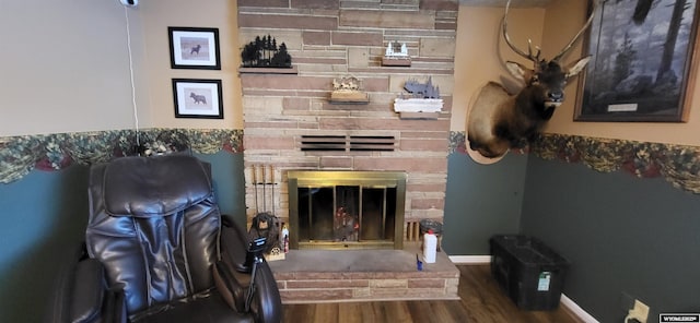 living room with a fireplace, wood finished floors, and baseboards