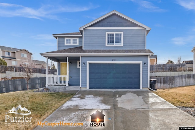 view of front of home with a garage, covered porch, and a front yard