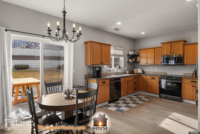 kitchen with hanging light fixtures, electric range oven, dishwasher, a notable chandelier, and light hardwood / wood-style floors