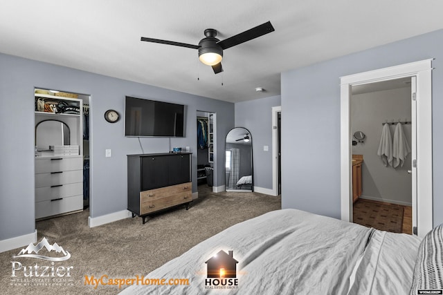 bedroom featuring ensuite bath, a spacious closet, carpet flooring, a closet, and ceiling fan