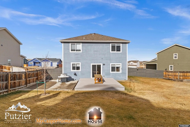 back of house with a patio area and a lawn