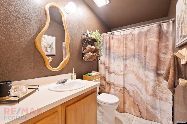 bathroom featuring tile patterned flooring, vanity, and toilet