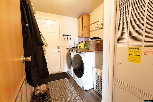 laundry room with cabinets, washing machine and dryer, and dark hardwood / wood-style floors