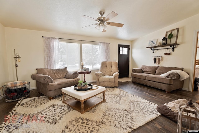 living room featuring dark hardwood / wood-style floors and ceiling fan