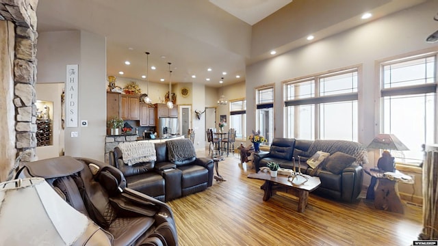 living room featuring a high ceiling and light hardwood / wood-style flooring