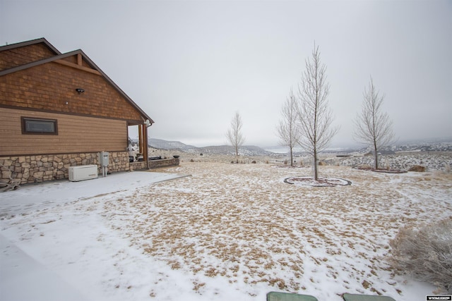 snowy yard featuring a mountain view