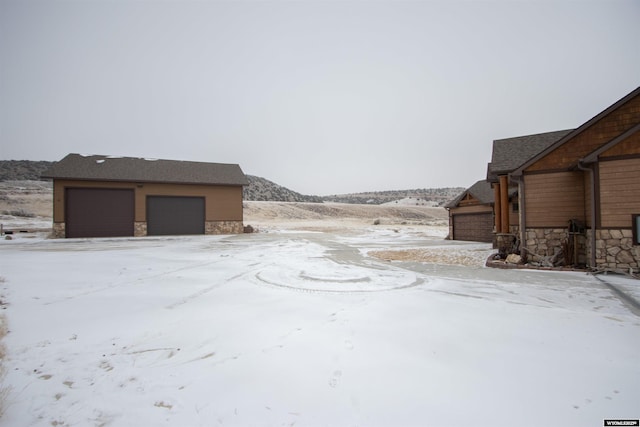 yard covered in snow featuring a garage