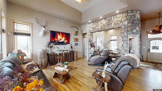 living room featuring ornate columns, a wealth of natural light, and hardwood / wood-style floors