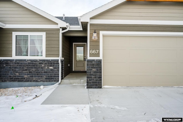 doorway to property with a garage