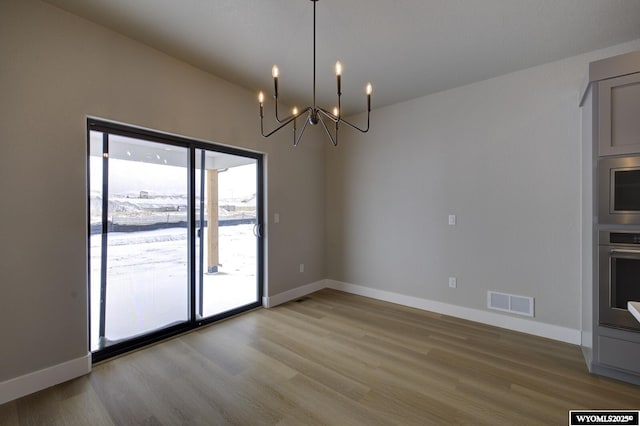 interior space featuring light wood-type flooring and a notable chandelier