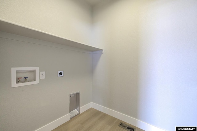 washroom featuring hookup for an electric dryer, washer hookup, and light hardwood / wood-style floors