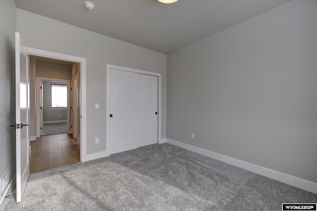 unfurnished bedroom featuring carpet and a closet