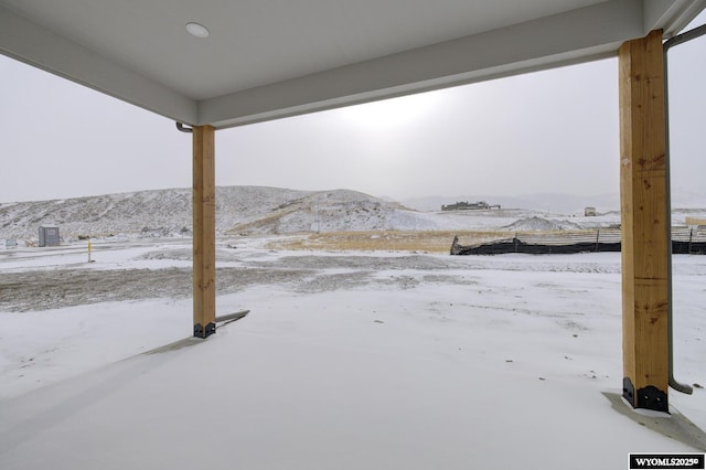 yard covered in snow with a mountain view